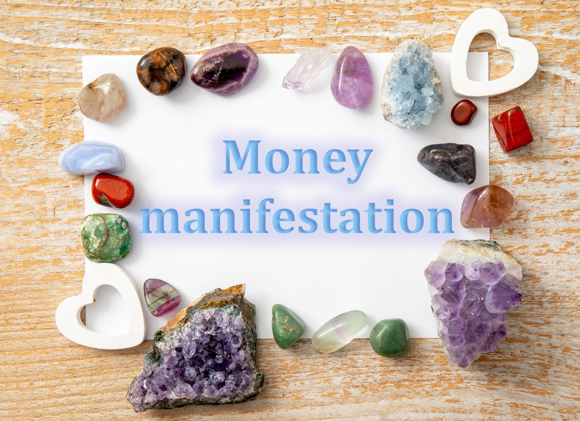 Money manifestation concept. Text with semi precious stones gemstones indoors.