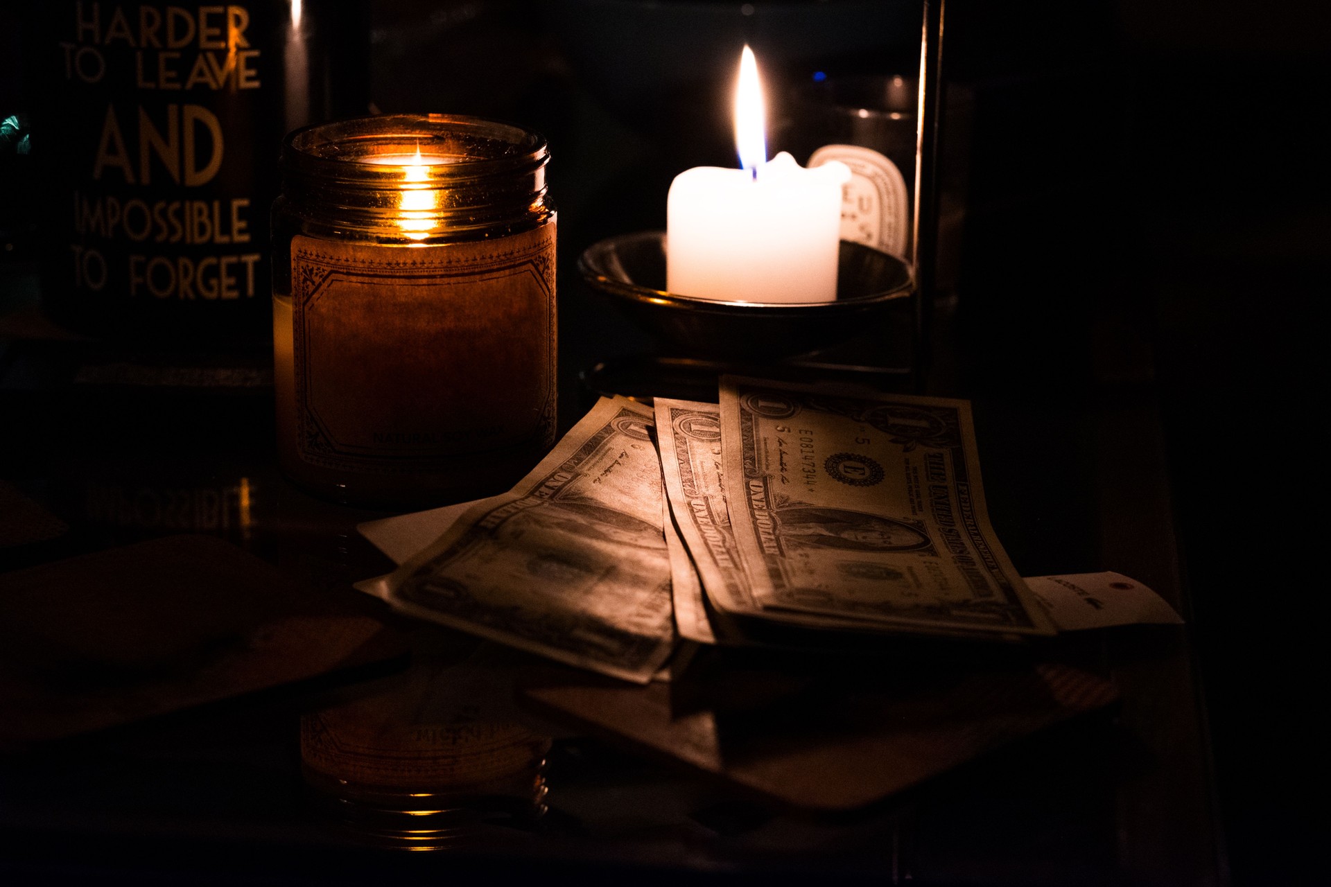 Candlelit Ambiance with Currency and Inspirational Message Highlighting Themes of Wealth, Inspiration, and Tranquility in a Rustic Setting